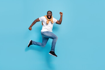 Fototapeta na wymiar Photo of shopper guy jump run hurry discount season wear t-shirt jumper front-tie isolated blue color background