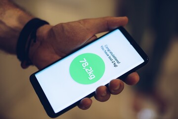 Man using weight loss application on his smartphone.