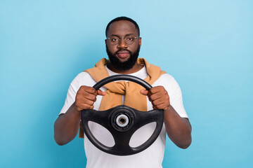 Photo of serious taxi driver hold steering wheel wear white t-shirt jumper front-tie isolated blue color background