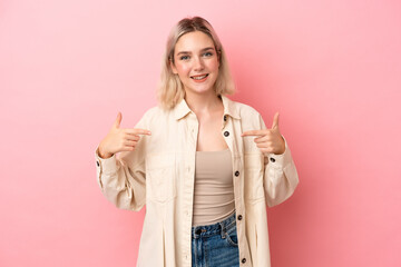 Young caucasian woman isolated on pink background proud and self-satisfied