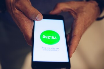 Man using weight loss application on his smartphone.