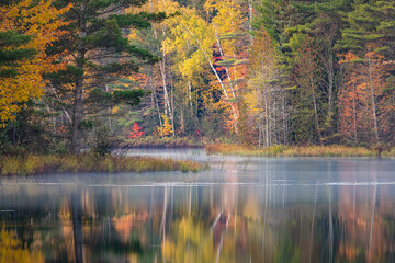 Autumn sunrise reflection on mirrored lake, Upper Peninsula of Michigan