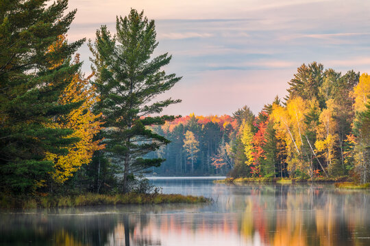 Autumn sunrise reflection on mirrored lake, Upper Peninsula of Michigan