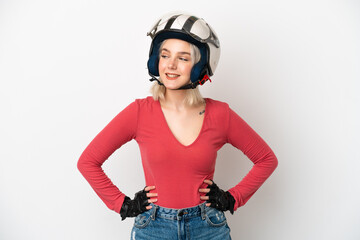Young caucasian woman with a motorcycle helmet isolated on white background posing with arms at hip and smiling