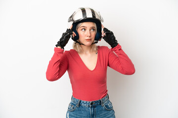 Young caucasian woman with a motorcycle helmet isolated on white background having doubts and thinking