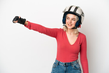 Young caucasian woman with a motorcycle helmet isolated on white background giving a thumbs up gesture