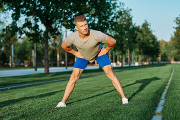 Fototapeta premium sporty man in the park on the lawn exercise lifestyle