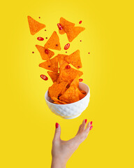 Levitation or flying of spicy hot Nachos mexican crispy crunchy tortilla chips with slices of chili...