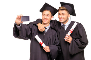 Happy graduates. Young handsome students taking selfie together. Isolated on white.