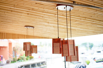 Wooden lanterns hanging on bamboo ceiling.