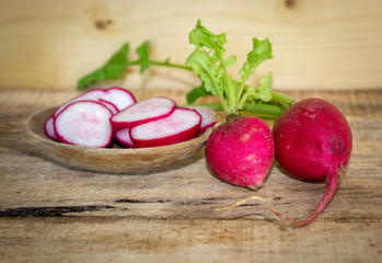 closeup of radish slices on a wooden spoon