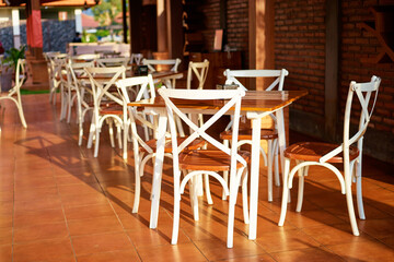 Outdoor cafe with wooden chairs.
