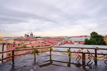 Fototapeta na wymiar Cafe terrace on the roof top with beautiful view of Saint Peterburg old town.