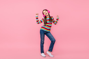 Photo of dreamy inspired little lady dance wear earphones striped shirt jeans shoes isolated pink color background