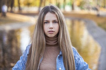 Naklejka premium Portrait of a young beautiful blonde girl in jeans jacket