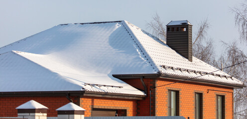 The roof of the house in the snow.