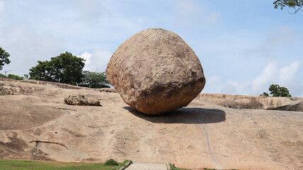 Krishna Butter Ball Large rock and blue sky. A balance rock. Located in the natural background. - obrazy, fototapety, plakaty