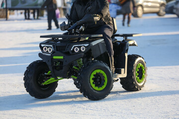 Naklejka premium The ATV rides in the snow