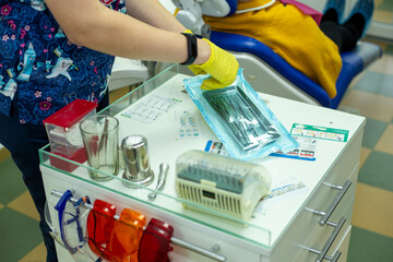 Dental office, the doctor prepares the tool for work, the tool is packed on a desktop