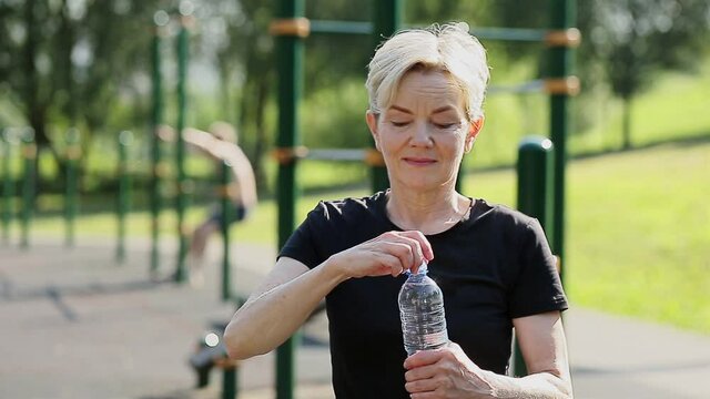 Senior woman with bottle of water