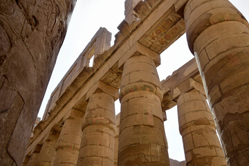 Ancient Egyptian hieroglyphs and symbols carved on columns of the complex of the Karnak temple....