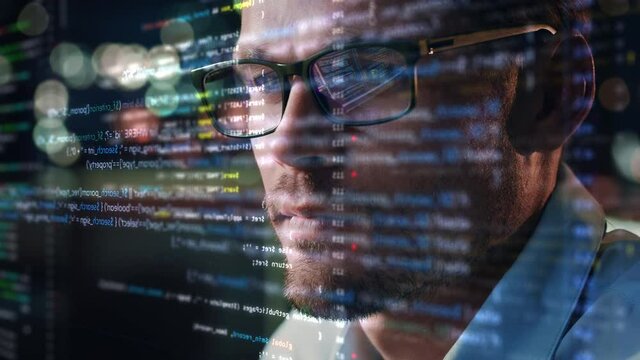 Portrait of Startup Digital Entrepreneur Working on Computer, Line of Code Projected on His Face and Reflecting in Glasses. Developer Working on Innovative e-Commerce App using AI and Big Data
