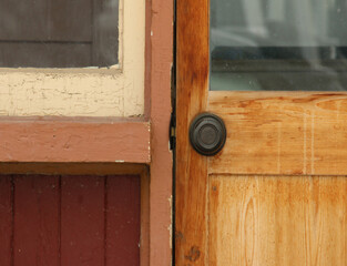 Close-up of  the doorknob, doorframe and latch of a wooden doorway.