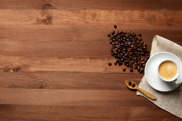 Obraz na płótnie Canvas A cup of coffee on a wooden table