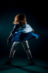 Fototapeta premium Athletic contemporary dancer isolated on dark wall