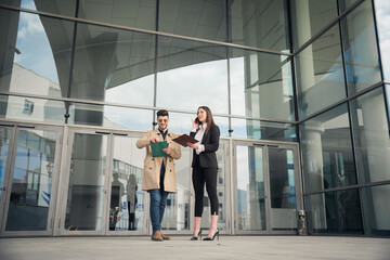 Business people are smiling in front of the company