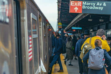 Subway train station in NYC, people commuting to work.