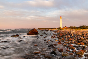 Tahkuna lighthouse on the windy coast during dusk at Hiiumaa, Estonia, Europe. A lighthouse on the...
