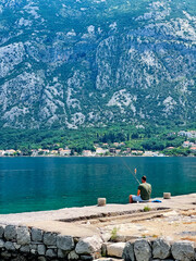 Fisherman on the shore of the Bay of Kotor in Montenegro