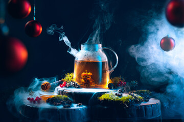 Magic of new year's eve. Tea pot with hot tea on Christmas decorated table. Cozy, happy home...