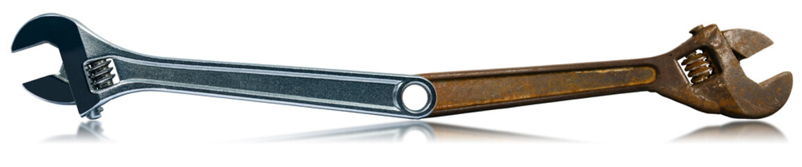 Closeup of two adjustable wrenches isolated on white background with reflections, one rusted and the other in stainless steel.