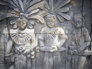 reliefs about the life of the indigenous people of Kalimantan on the walls of the city center park building