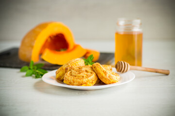 sweet lush pumpkin pancakes with honey in a plate