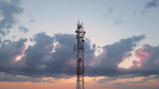 Telecommunication tower of 4G and 5G cellular or Base Transceiver Station. Wireless Communication Antenna Transmitter. Aerial view of antennas against sunset sky