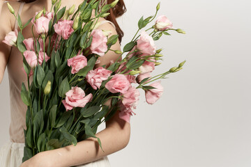 attractive woman with a bouquet of flowers isolated background