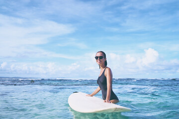 Extreme Water Sport. Surfing. Healthy Athletic Young Surfer Girl With Sexy Fit Body Holding Surf Board While Standing In Clear Water, Summer Vacation. Lifestyle. Leisure, Hobby, Wellness, Fitness.