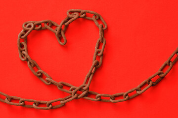 Heart made of iron chain on red background - Love and freedom concept