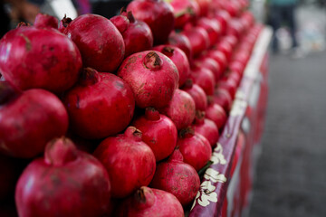 Fresh fruits. Red pomegranates on the street market.