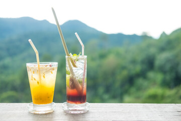 Summer drink on the table with mountains landscape background.