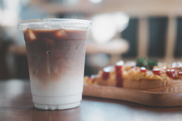 Ice coffee with milk in takeaway cup showing separately in a layer