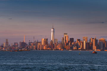 Travel to New York. Sunset over the skyline of Manhattan, one of the most touristic cities in the world. Amazing view to its skyscraper tall office buildings.