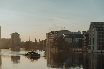 Fototapeta premium sailing ship on river Spree in berlin during the autumn sunrise