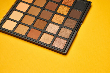 cosmetics mascara brushes decoration accessories yellow background