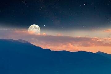 foggy mountains on sunset orange  evening starry blue night sky big bright moon foggy Olympus mount...