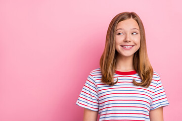 Photo of optimistic little girl look promo wear striped t-shirt isolated on pink color background