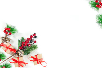 Fototapeta na wymiar christmas fir branches with red berries and gift boxes on a white background, isolate